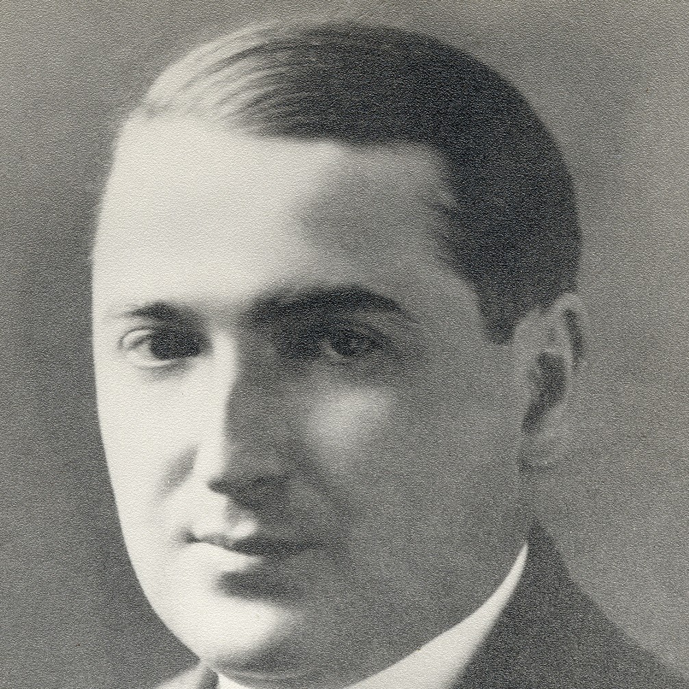 A black and white photograph of Emil Post. He faces the camera in a three-quarters perspective. His hair is dark and slicked back to the side. He is wearing a suit and tie.